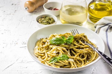 Spaghetti with homemade pesto sauce on a white background. selective focus