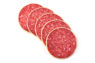Salami. Smoked sausage thinly sliced, isolated on white background. Top view.