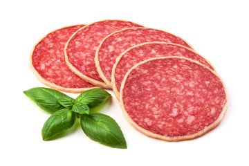Salami with basil leaf. Smoked sausage thinly sliced, isolated on white background.