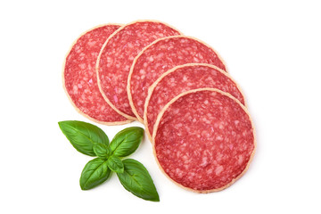 Salami with basil leaf. Smoked sausage thinly sliced, isolated on white background. Top view.