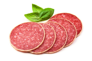 Salami with basil leaf. Smoked sausage thinly sliced, isolated on white background.