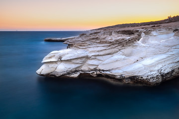 Alamanos white rocks by the sea, during sunset