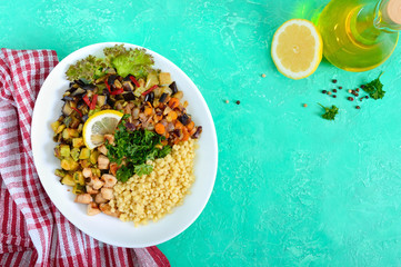 Delicious oriental salad tabbouleh. Couscous with fried vegetables and chicken on a white plate. Traditional Lebanese appetizer. The top view