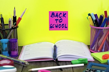  Back to school concept: close-up of school supplies with back to school background.