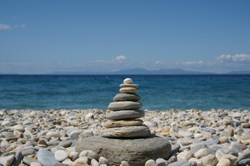 Stone tower on a beach covered with pebble