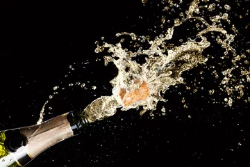 Poster Bar Celebration theme with explosion of splashing champagne sparkling wine on black background.