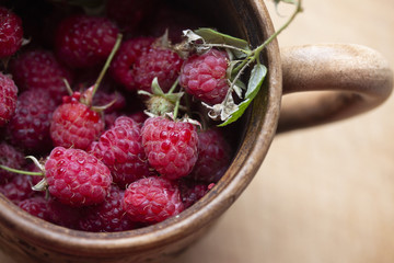 juicy sweet berries of homemade raspberries in a mug