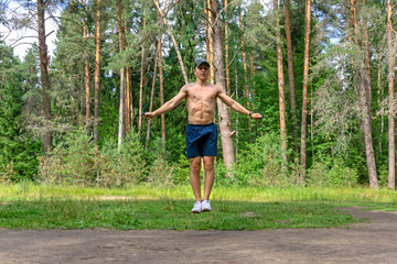 Young man jumping rope in the park