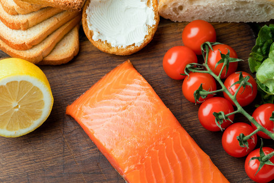 slamon fillet with ingredients on wooden background