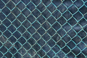 metal texture of an old blue grid on a black background