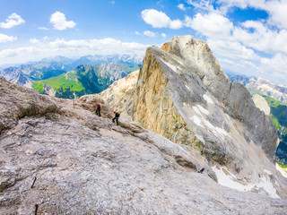  Via ferrata Tofana di Mezzo climbers on the ridge in the Dolomites, Group of climbers on the mountain top, Dolomite Alps, Italy. Silhouette of people climbing the mountain. Tiny Man Big Landscape 