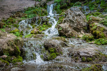 Naklejka na ściany i meble View of cascading water falling over the rocks. Waterfall of The Seven Springs in Gauja national park. Latvia.