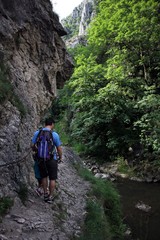 Man walking on a dangerous path in canyon