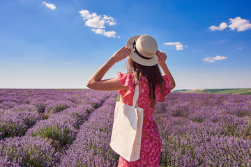 girl in a straw hat looks at the sky