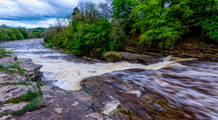 Dramatic shot of raging water cascading down river