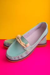 blue moccasins on magenta and yellow background