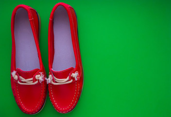 red moccasins on a green background