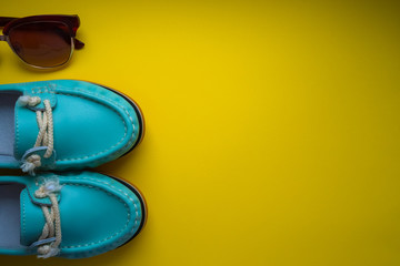 blue moccasins with glasses on a yellow background