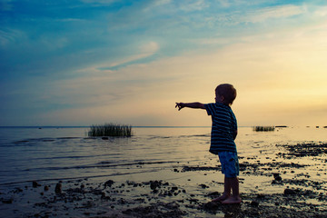 child on the beach. the child is looking forward