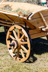 Wooden cart with hay for decor during traditional harvest fair