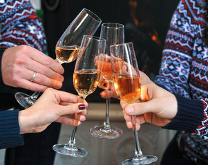 Four glasses with champagne in a friendly company. Close-up
