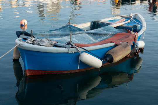 Old fishing harbor with colorful wooden boats in old small city Giovinazzo near Bari, Apulia, Italy in early morning