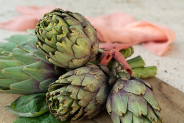 Fototapeta premium Traditional Italian food, fresh green artichoke vegetables, new harvest, uncooked