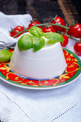 Italian soft cheese, young white ricotta cheese served with fresh basil and tasty ripe cherry tomatoes