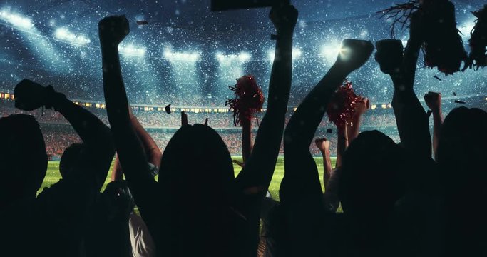 Fans celebrating the success of their favorite sports team on the stands of the professional stadium while it's snowing. Stadium is made in 3D and animated.