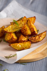 grilled potatoes rosemary wooden background
