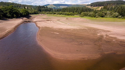 Aerial drone view of a dried up reservoir during a heatwave in summer