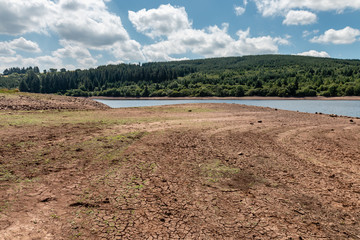 Fototapeta na wymiar A near dry reservoir in the UK caused by drought and a heat wave ( Llwyn-On Reservoir)