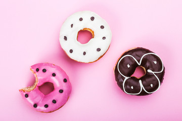 Colorful glazed donuts, top view over white background, isolated