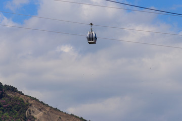 Cabin of the cable car against blue sky. Cableway in Tbilisi, Georgia