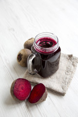 Beetroot juice in glass jar, side view. Copy space.