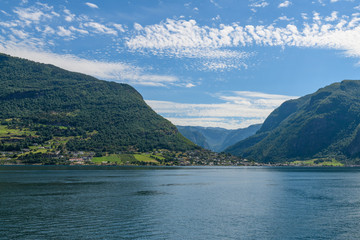 View from the fjord towards the village of Flom.  Neroyfjord offshoot of Sognefjord is the narrowest fjord in Europe. Sogn og Fjordane,  Norway, Europe.