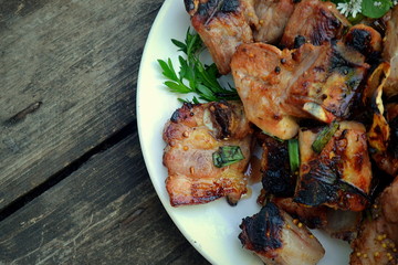 Pork shish kebab close-up on a wooden table.