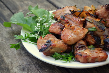 Pork shish kebab close-up on a wooden table.