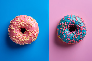 Colorful tasty glazed donuts on a colored background.