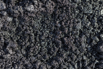 Texture of fresh hot asphalt. Black background resembling anthracite.