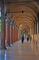 Bologna, Italy, local and tourists walking in Santo Stefano square portico. 