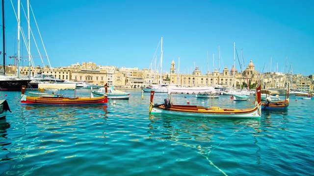 Traditional Malteze dghajsa water taxies in harbor of Birgu (Vittoriosa), a view from Senglea, Malta