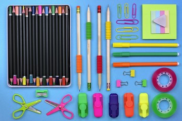 School and office accessories on a blue paper background.