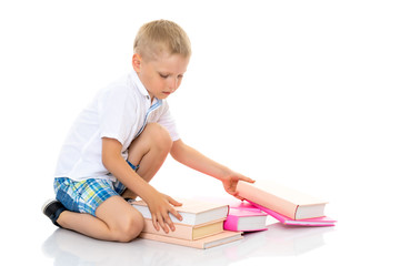 A little boy with books.