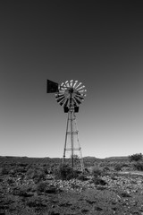 Close up image of a windpump / windmill /windpomp against a bright blue sky in the karoo of south africa