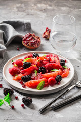 Salad with berries, grapefruit and pomegranate seeds. Healthy food