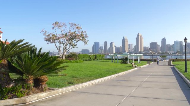 View from Coronado Island to downtown San Diego City in the early morning on a sunny day. Beautiful lawn with flowers in the Big City.