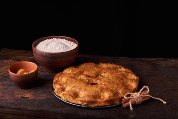 apricot pie and a bowl with flour and other ingredients and tools table