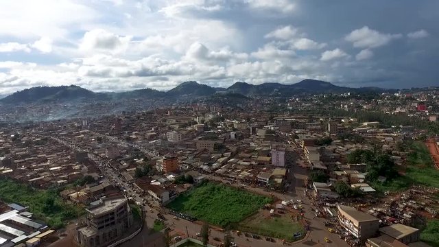 Descending into Yaound&eacute; with hills view of residential apartment buildings on a summer day