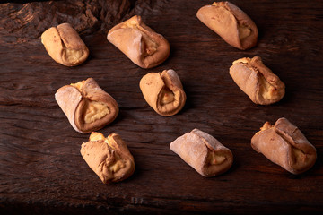 fresh pies with cottage cheese from a yeast dough on a wooden desk, baking with cottage cheese. Concept of small business bakery